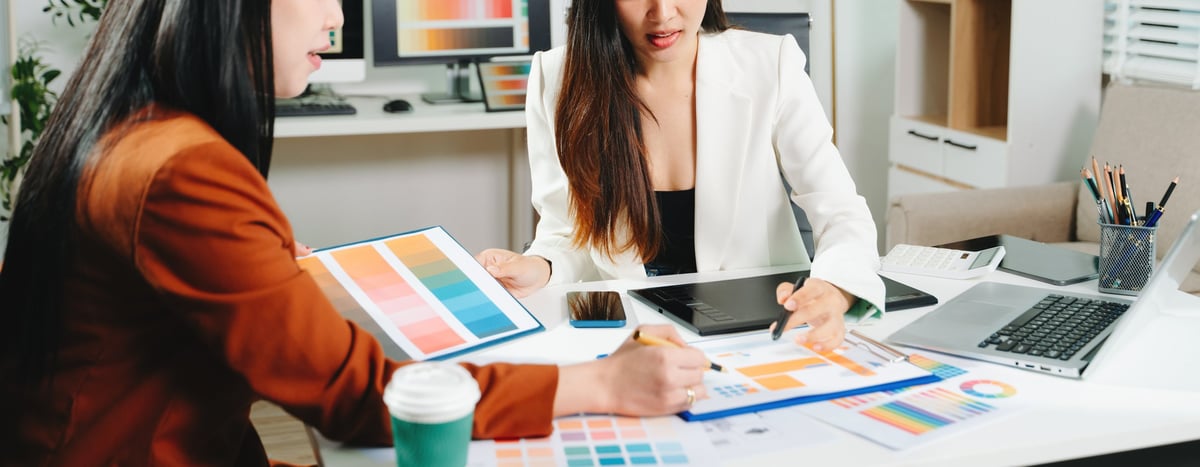 Two designers collaborating on a color palette and user interface project